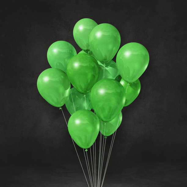 istock Green balloons bunch on a black wall background 1312749324