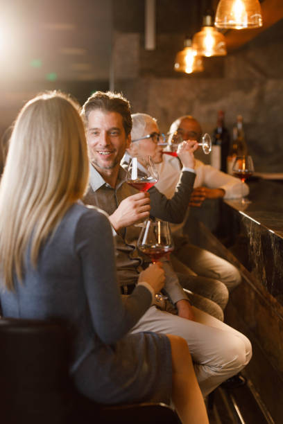istock Happy business colleagues having drinks in a bar. 1312750230