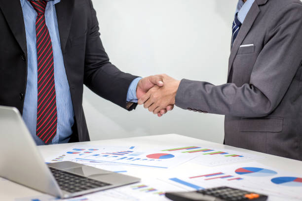 istock Business shaking hands. Business executives shaking hands to congratulate the joint. 1312752291