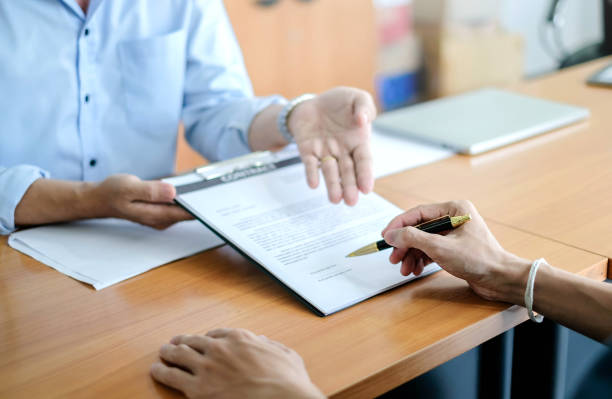 istock Man signing a contract. Signing an agreement in a document 1312752333