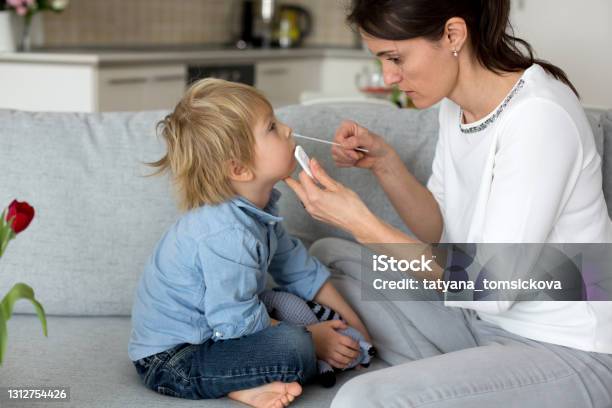 Mother Testing Her Child For Covid At Home Making Home Allowed Swab Tests Stock Photo - Download Image Now