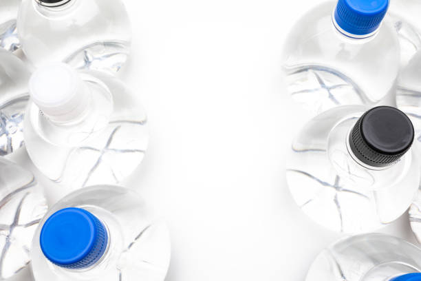 istock Background of transparent spherical water bottles with colored caps. With copy space. 1312755329