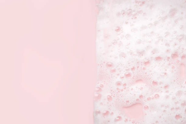istock White foam bubbles texture on pink pastel background, copy space, banner for loundry, cleaning service, bathroom concept, clean, wash - liquid soap, shower gel, shampoo 1312755365