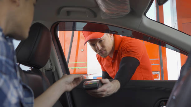 istock A caucasian man people worker collecting gas bill payment by using EDC machine with a credit card at gasoline petrol station, an online payment option refuel oil and energy vehicle business service. 1312757797