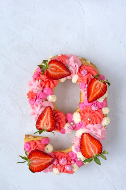 istock Birthday cake. Unusual modern design with strawberries. Spring time. Postcard for the holiday. Congratulations are bright and creative. Beautiful cake in the shape of number 9 1312757810