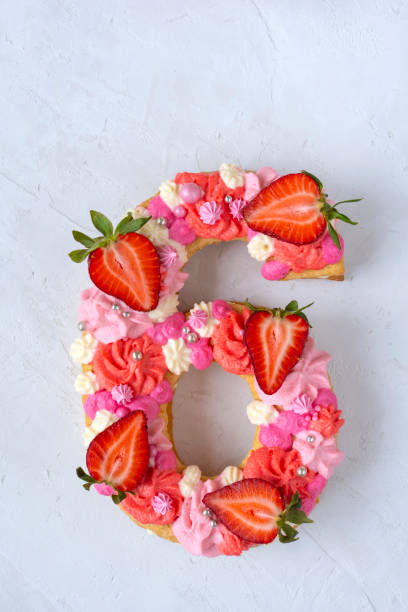 istock Birthday cake. Unusual modern design with strawberries. Spring time. Postcard for the holiday. Congratulations are bright and creative. Beautiful cake in the shape of number 6 1312757811