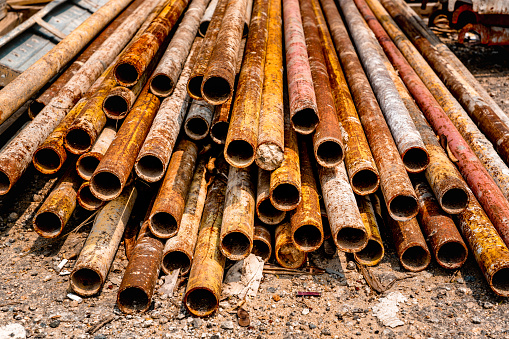 Rusty metal pipes and beams at construction site