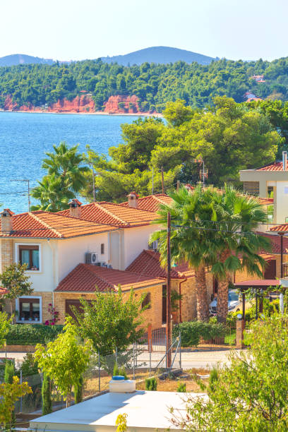 Nikiti, Sithonia, Chalkidiki Peninsula, Greece panorama with houses, blue sea and red rocks mountains