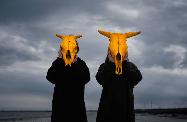 istock People With Yellow Mask Standing By Sea Against Cloudy Sky 1312761419