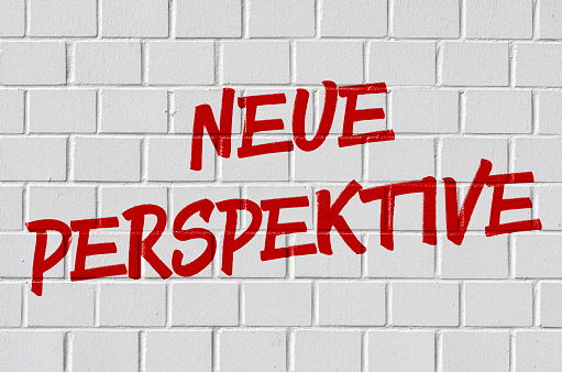 Graffiti on a brick wall - New perspective in german - Neue Perspektive