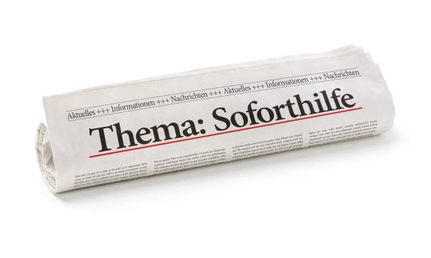 istock Rolled newspaper with the headline Emergency Aid in german - Soforthilfe 1312761812