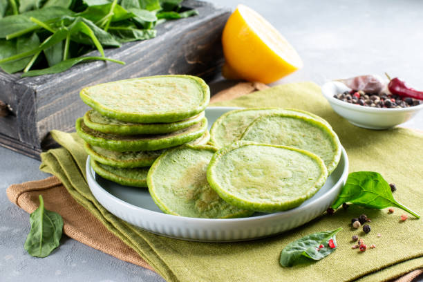 istock Spinach pancakes with spinach on a table. Gluten free spinach pancakes recipe 1312763784