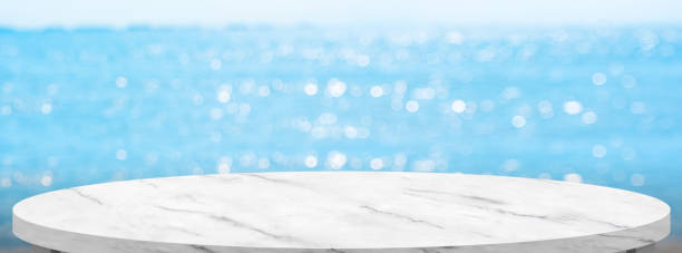 istock Empty round marble table with summer blue sea blur background.copy space for display of product on online media 1312766971