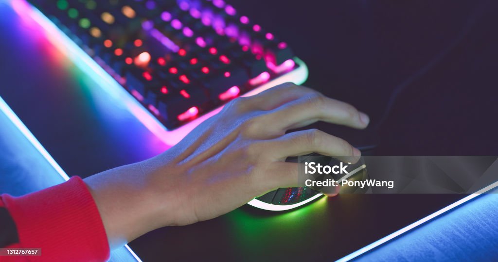 Esport RGB mouse and keyboard close up of pro cyber sport gamer play game with RGB keyboard and mouse Computer Mouse Stock Photo