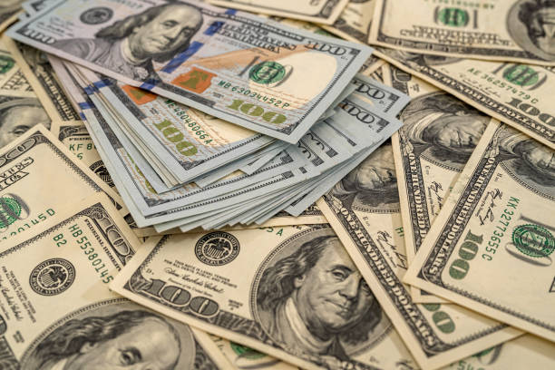 istock Background of US dollar bills. Top view point. 1312769010