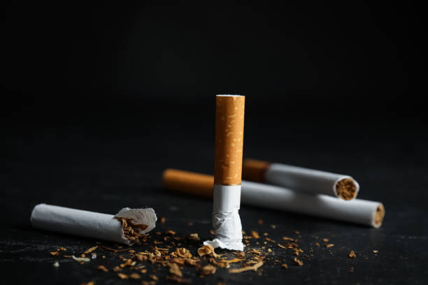 Broken and whole cigarettes on black table, closeup. Quitting smoking concept Broken and whole cigarettes on black table, closeup. Quitting smoking concept smoking issues photos stock pictures, royalty-free photos & images