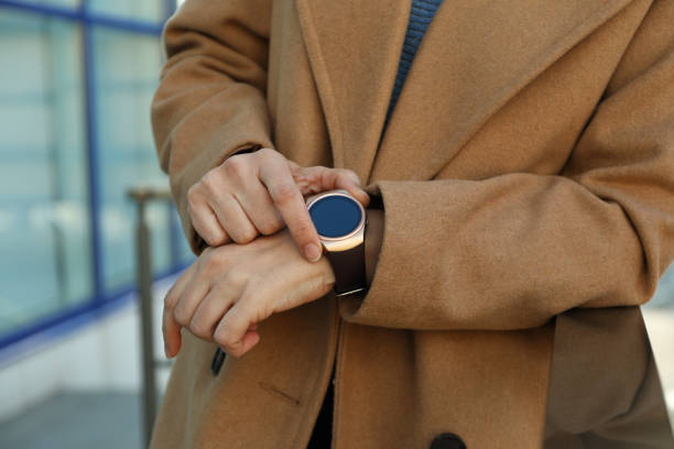 istock Mature woman using smart watch outdoors, closeup 1312769769
