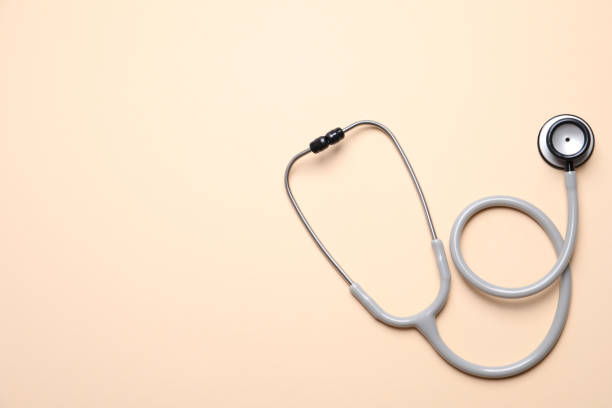 istock Stethoscope on beige background, top view. Space for text 1312769790