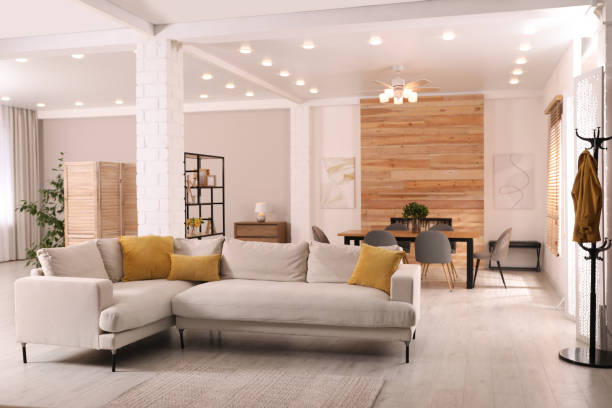 Stylish living room interior with comfortable sofa and wooden table