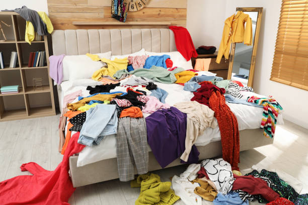 Pile of clothes on bed in messy room. Fast fashion concept Pile of clothes on bed in messy room. Fast fashion concept messy stock pictures, royalty-free photos & images