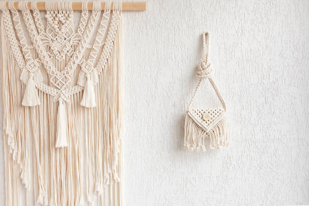 istock Handmade white macrame bag and wall hanging on the white wall, ECO friendly. Hobby knitting handmade macrame. Modern summer concept. Copy space 1312772872