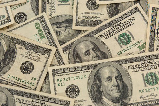 istock Background of US dollar bills. Top view point. 1312773010