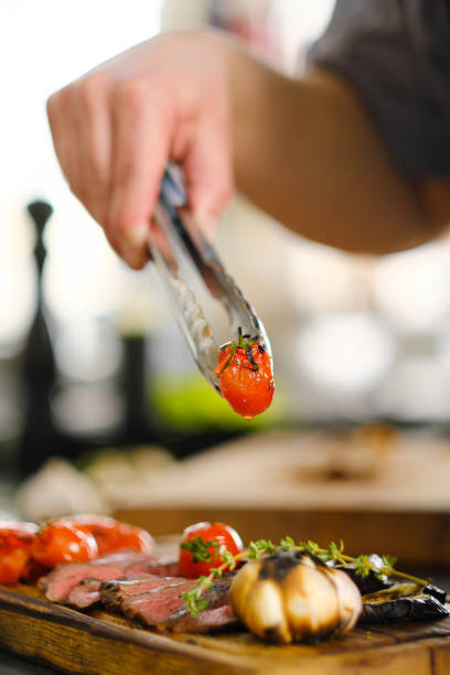 istock The male chef serves a meat dish and decorates steak. The restaurant's kitchen. 1312775113