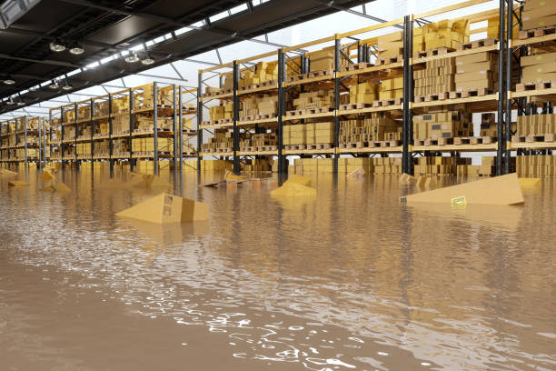 almacén inundado con cajas de cartón flotando en el agua - flood fotografías e imágenes de stock