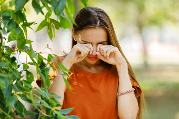 istock Young Woman with Sight Problems is Rubbing her Eyes in a Park. 1312778319