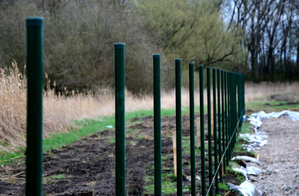 istock fence with a lower part which is made of concrete slabs 1312779581