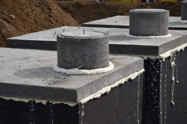 istock Installation of concrete tanks painted with black insulating asphalt paint. 1312779718