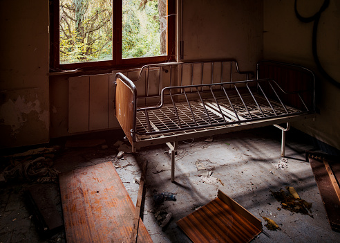 Old bed frame in abandoned place