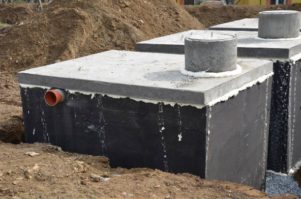 istock Installation of concrete tanks painted with black insulating asphalt paint. 1312780164