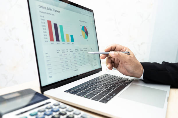 istock Asian accountant working and analyzing financial reports project accounting with chart graph and calculator in modern office, finance and business concept. 1312782588