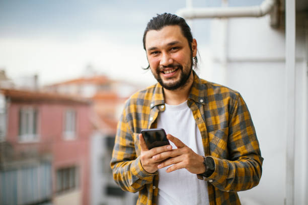 istock Young Man With Smart Phone In Sunny Weather 1312784147