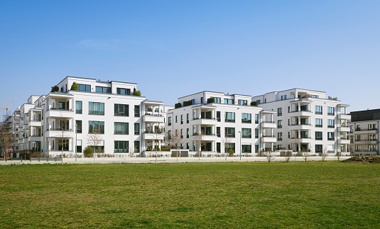 High resolution photograph of new luxury townhouses with a lawn in the foreground,  Duesseldorf, Germany.