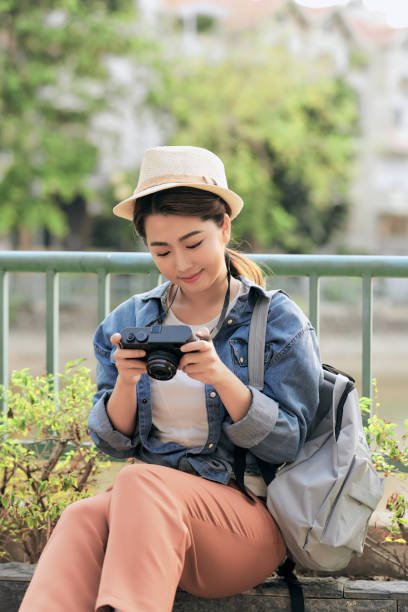 istock Young girl with a camera outdoors 1312787621