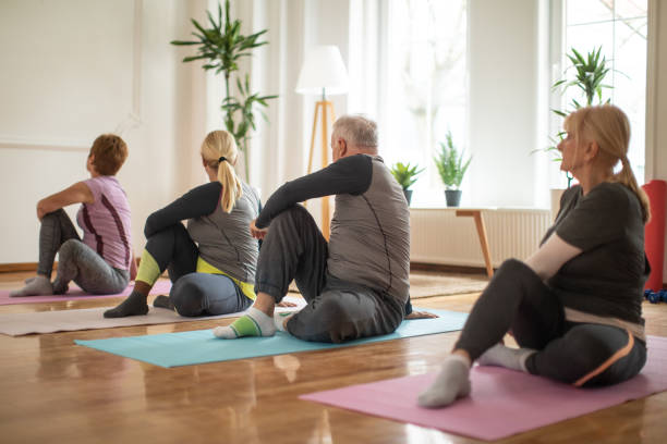 istock Senior people enjoying yoga class in yoga studio 1312787949