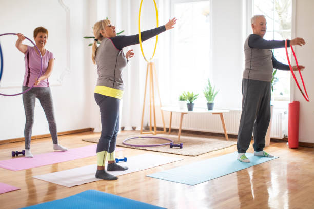 istock Senior people having fun with hula hoop during exercise class 1312787996