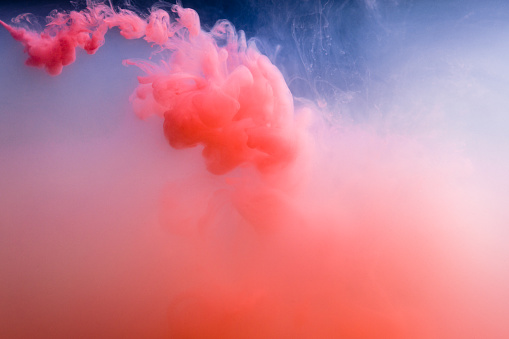 Pink ink cloud underwater. Abstract background.