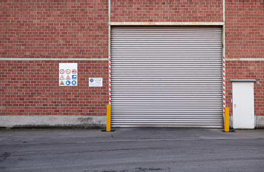 Rolling garage door, truck gateway of an industrial building..
