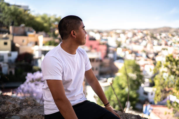 istock Young man looking away contemplating outdoors 1312788205