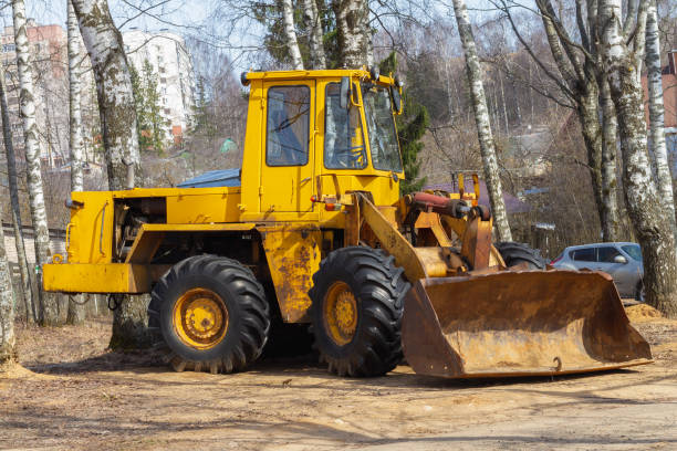 istock Large yellow bulldozer in a forest or park near trees, deforestation 1312788382