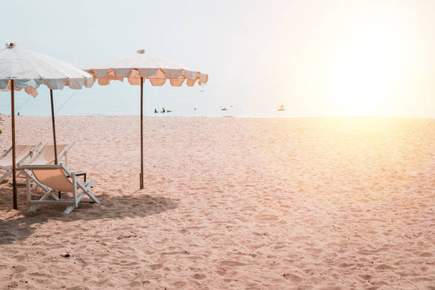 istock Deckchairs And white Parasol In The Tropical Beach 1312790915