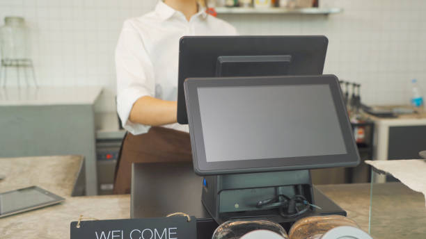 istock Woman barista people in apron working on POS system machine with blank empty space screen monitor on counter, cafe restaurant cashier. waitress in coffee shop. People lifestyle. Business service. 1312793576