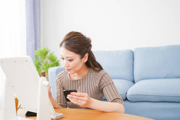 istock A woman applying makeup in a room 1312794854