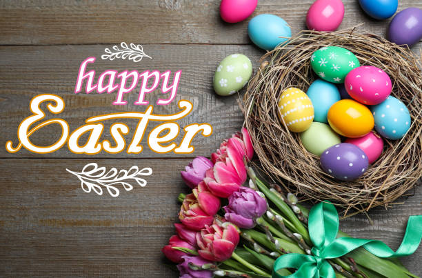 istock Happy Easter. Bright painted eggs and tulips on wooden table, flat lay 1312794878