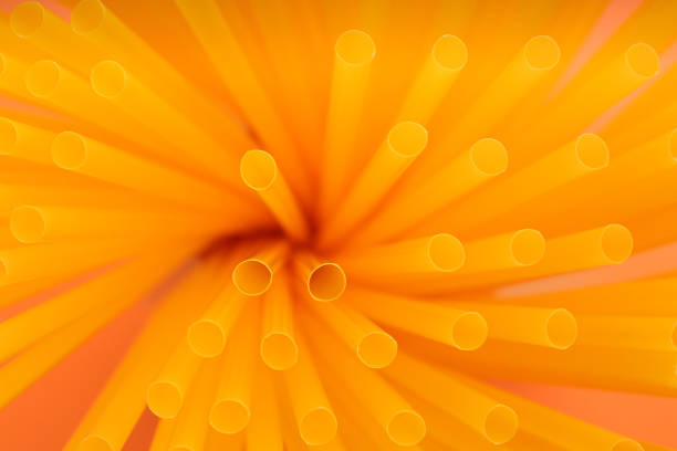 istock Heap of yellow plastic straws for drinks as background, closeup 1312795100