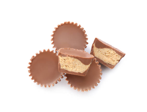 istock Cut and whole delicious peanut butter cups on white background, top view 1312795265