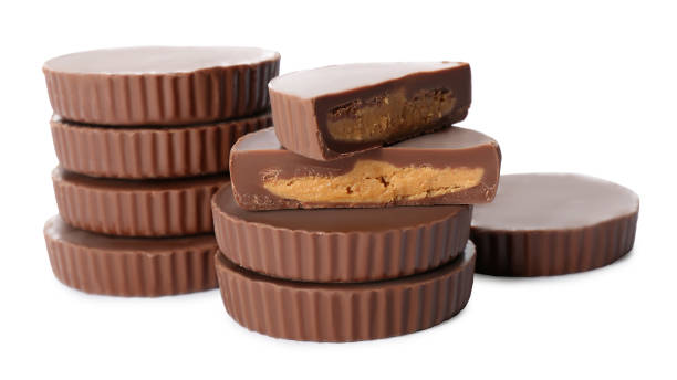 istock Cut and whole delicious peanut butter cups on white background 1312795279